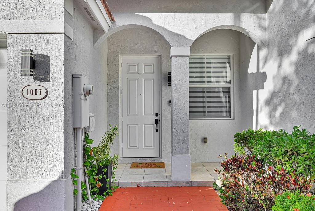1007 Northeast 208th Street, Unit 1007 Miami, FL 33179 - Photo 4 of 68 a front view of a house with garden