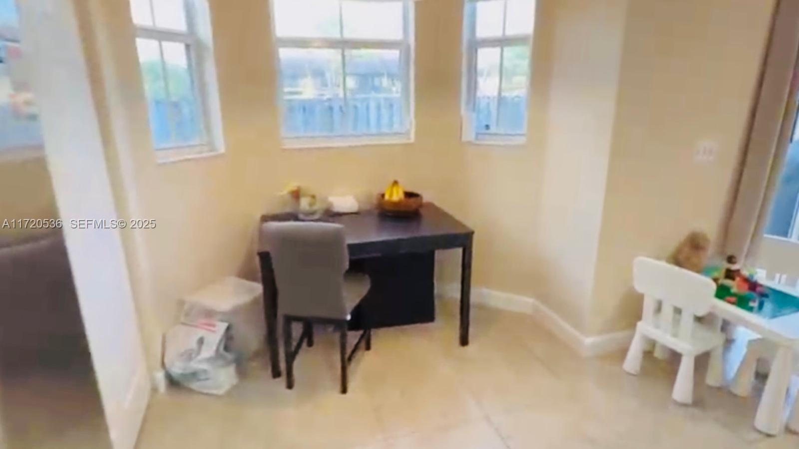 1007 Northeast 208th Street, Unit 1007 Miami, FL 33179 - Photo 45 of 68 a workspace with furniture and a window