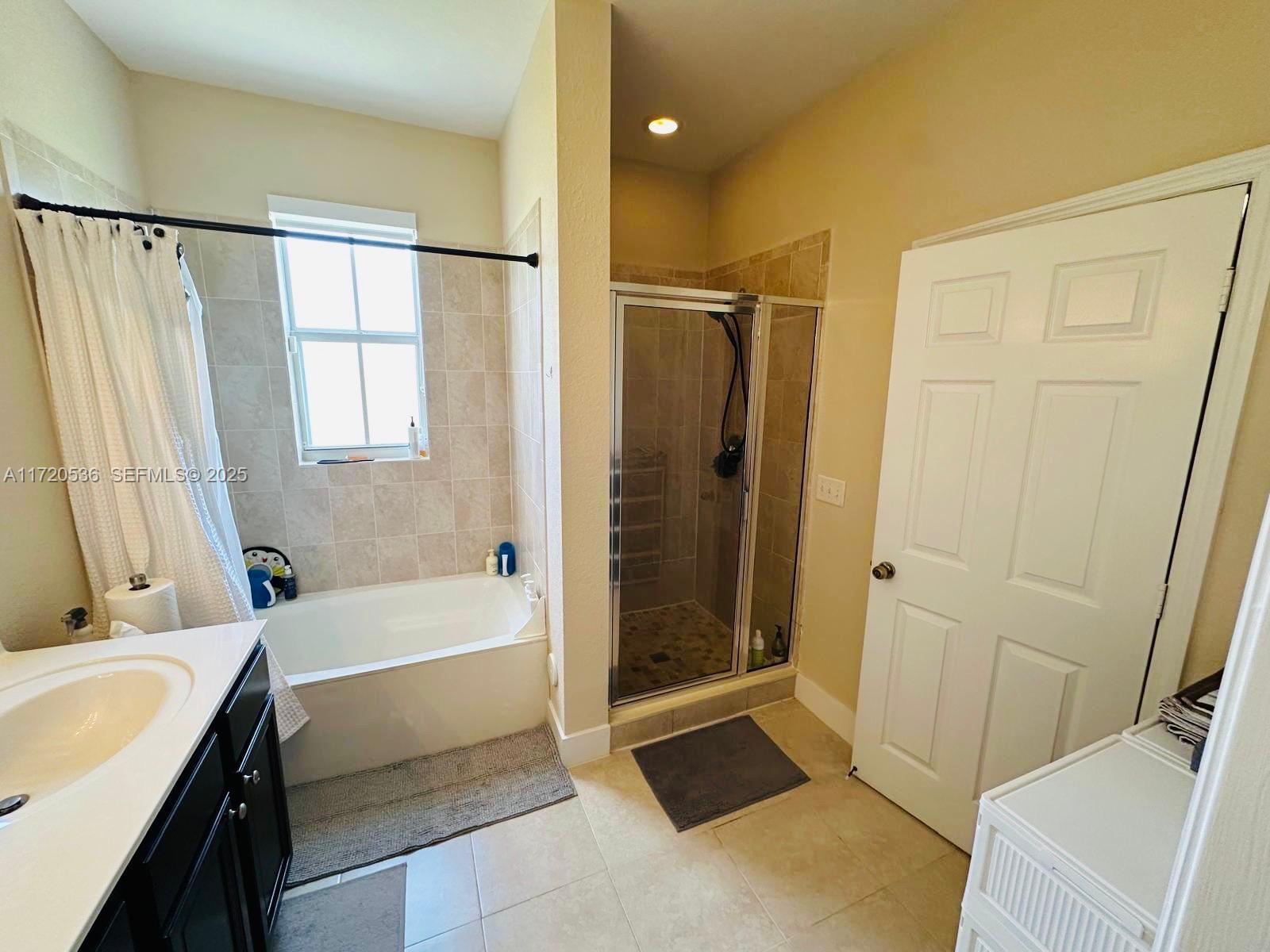 1007 Northeast 208th Street, Unit 1007 Miami, FL 33179 - Photo 55 of 68 a bathroom with a tub a sink and a shower