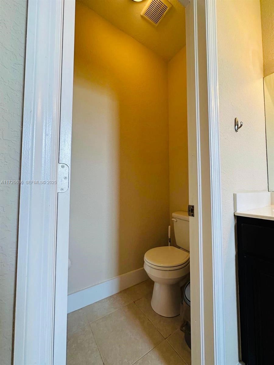 1007 Northeast 208th Street, Unit 1007 Miami, FL 33179 - Photo 59 of 68 a bathroom with a toilet and a shower