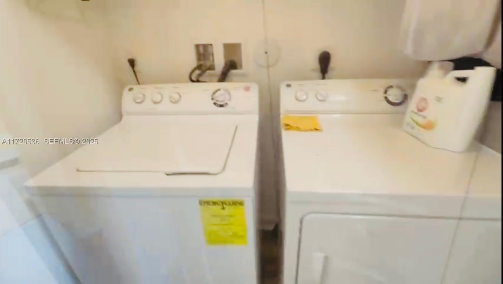 1007 Northeast 208th Street, Unit 1007 Miami, FL 33179 - Photo 60 of 68 a utility room with dryer and washer