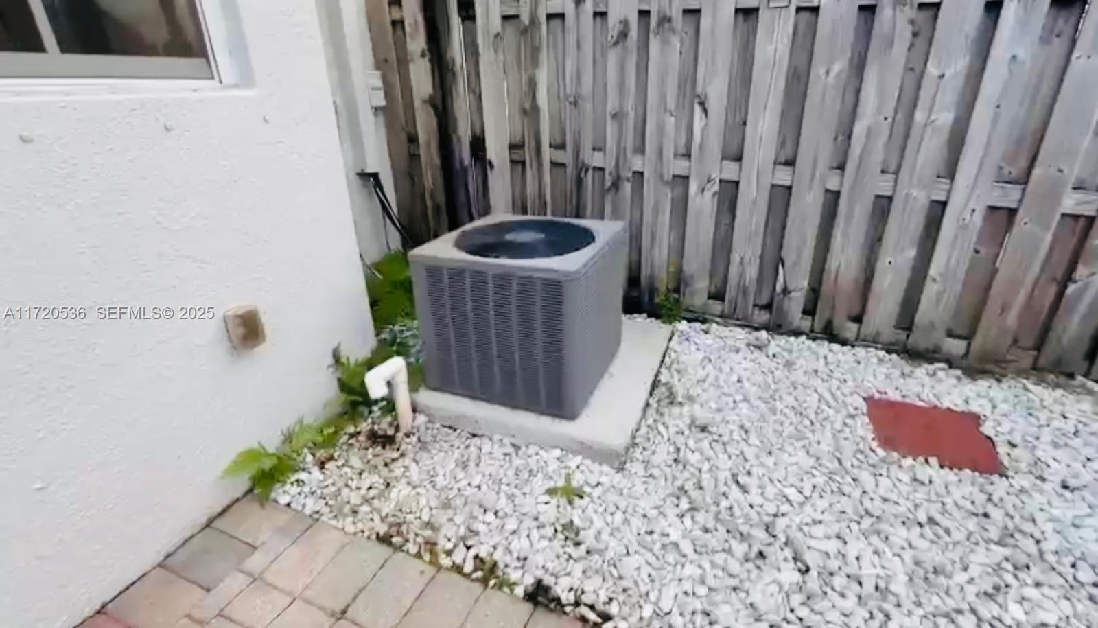1007 Northeast 208th Street, Unit 1007 Miami, FL 33179 - Photo 68 of 68 a view of a wooden door with a small yard