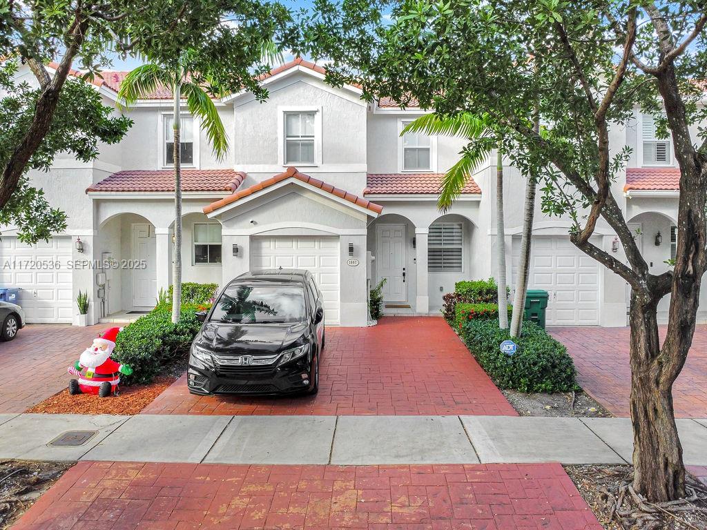 1007 Northeast 208th Street, Unit 1007 Miami, FL 33179 - Photo 9 of 68 a front view of a house with a porch