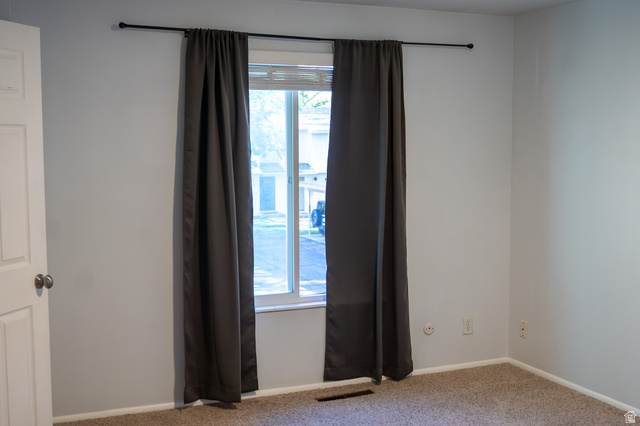 1269 North 400 East, Unit 3 Logan, UT 84341 - Photo 19 of 23 Room featuring light gray walls, a double-pane window, and carpet flooring