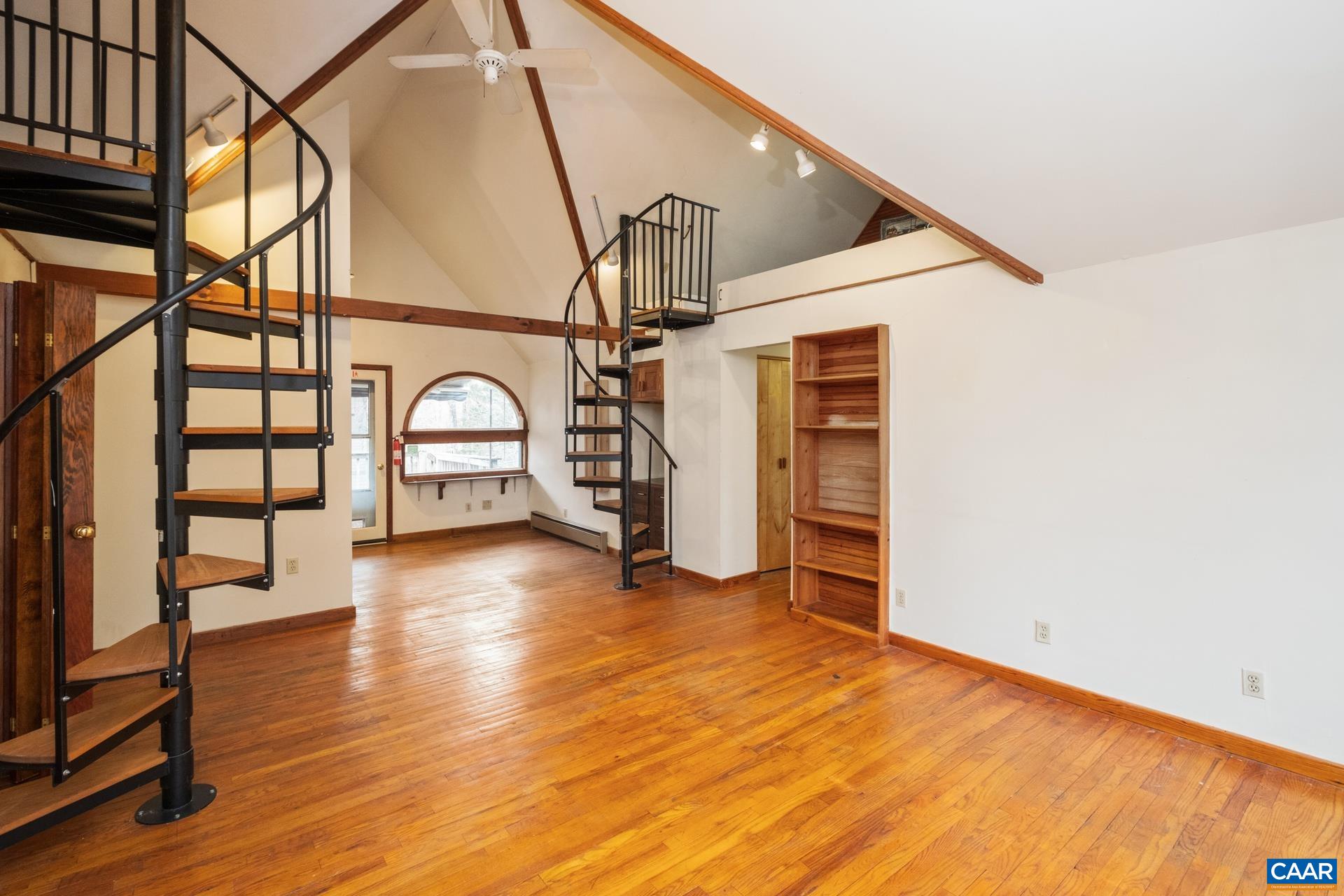 122 Seville Road Rochelle, VA 22738 - Photo 19 of 40 a view of a livingroom with wooden floor and stairs