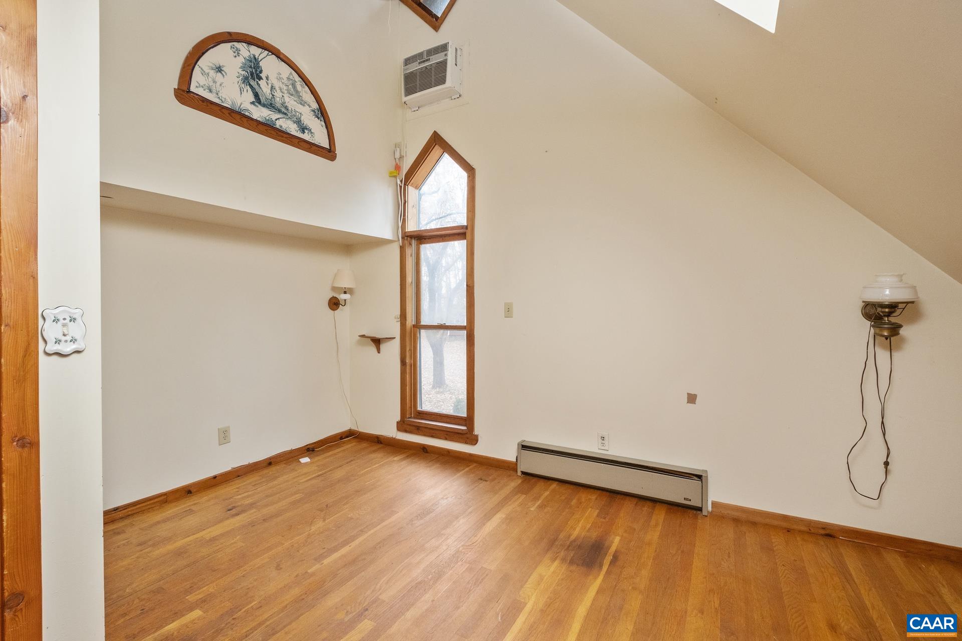 122 Seville Road Rochelle, VA 22738 - Photo 23 of 40 an empty room with wooden floor and mirror
