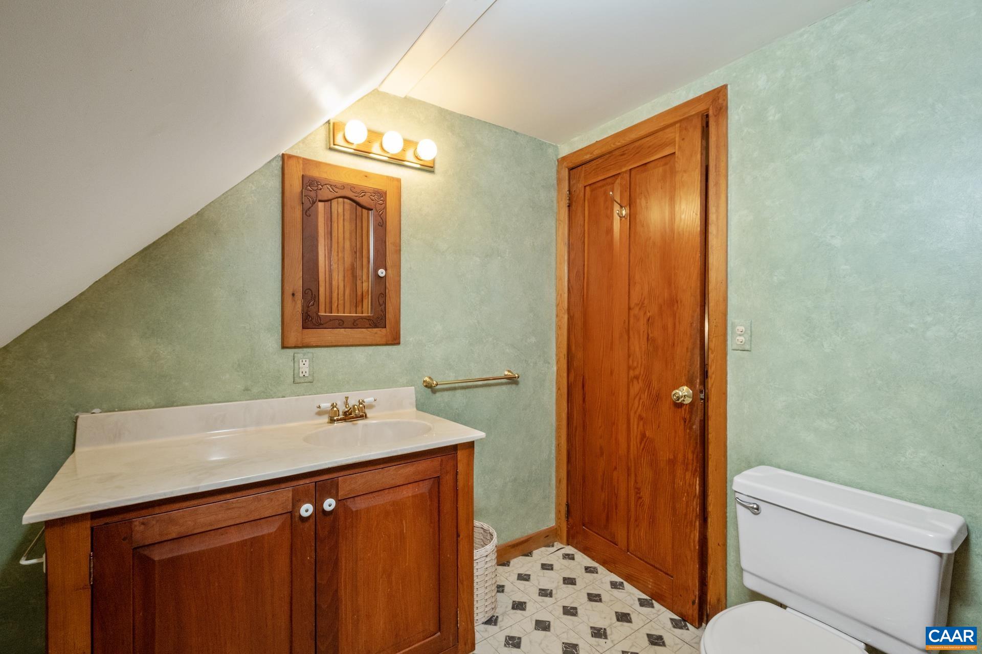 122 Seville Road Rochelle, VA 22738 - Photo 26 of 40 a bathroom with a sink a toilet a mirror and shower