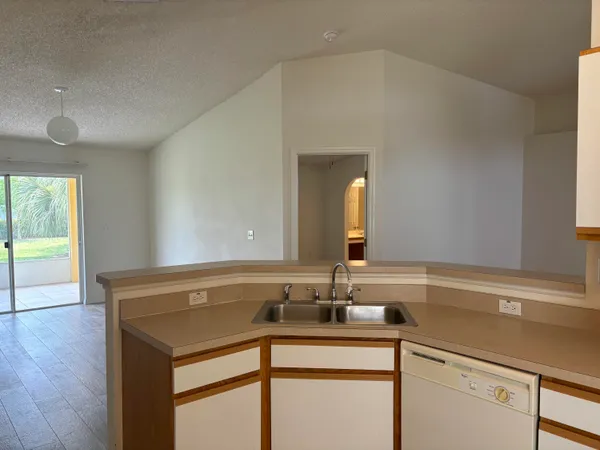 a kitchen with a stove a sink and a refrigerator