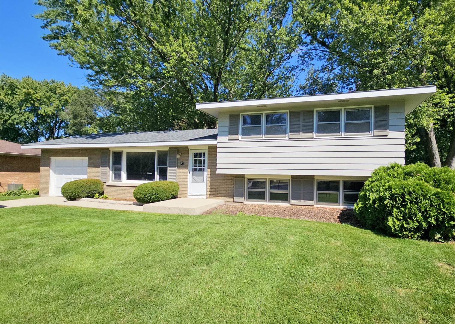827 Balmoral Drive East Dundee, IL 60118 - Photo 1 of 16 a front view of a house with a yard and potted plants