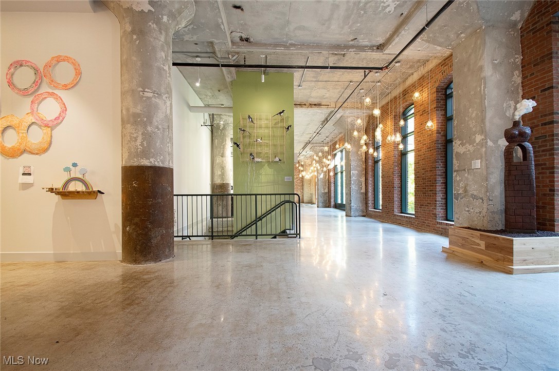 725 Johnson Court, Unit 220 Cleveland, OH 44113 - Photo 3 of 25 Building lobby with a high ceiling and art displays. Large common area for public and private events