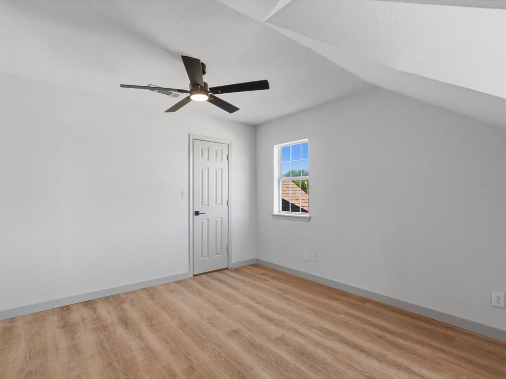 289 County Road 4655 Rhome, TX 76078 - Photo 19 of 34 Upstairs bedroom featuring wood-finish flooring, a contemporary ceiling fan with integrated lighting