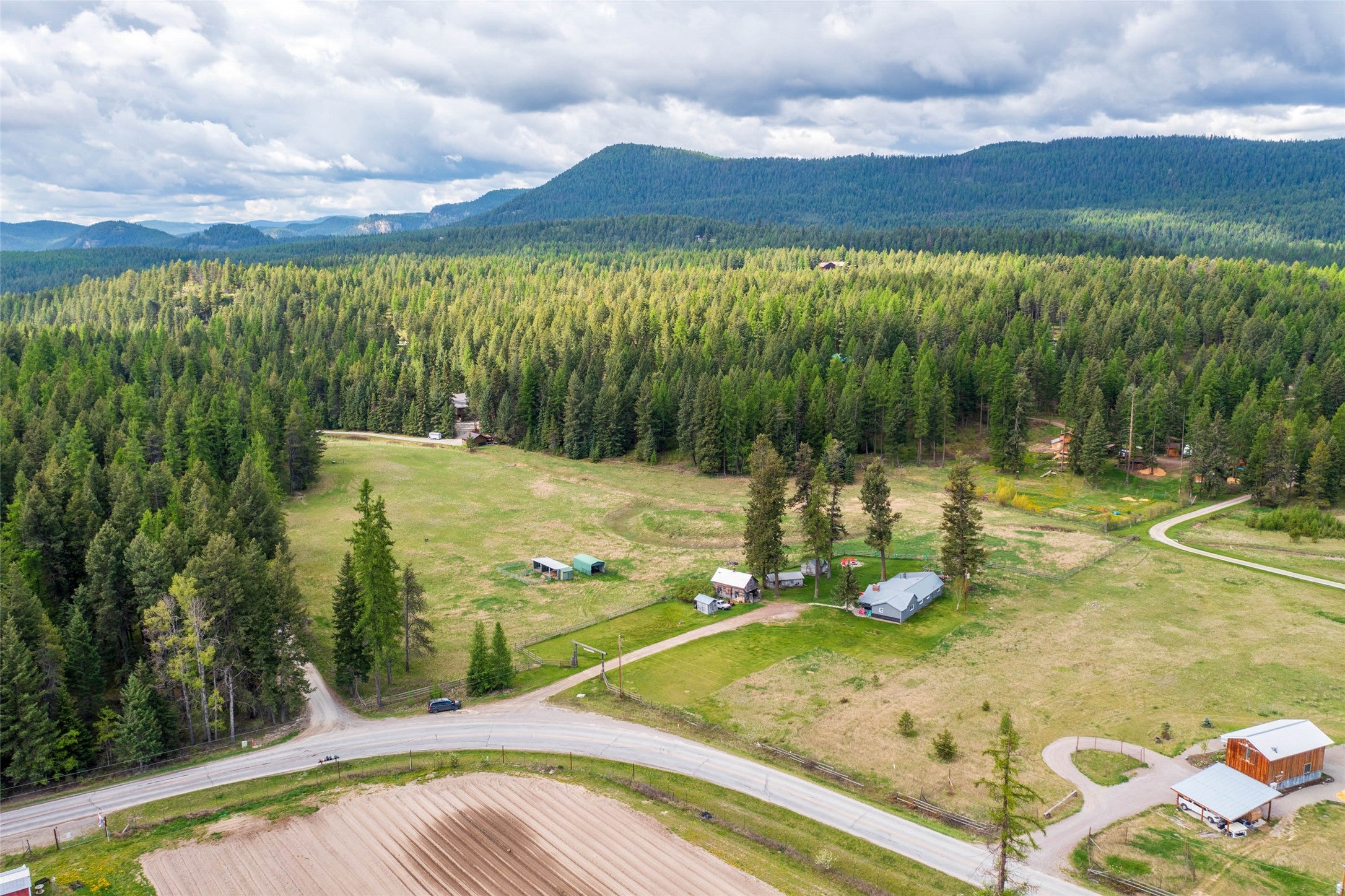 6550 Farm To Market Road Whitefish, MT 59937 - Photo 1 of 1 Bird's eye view with a wooded view and a mountain view