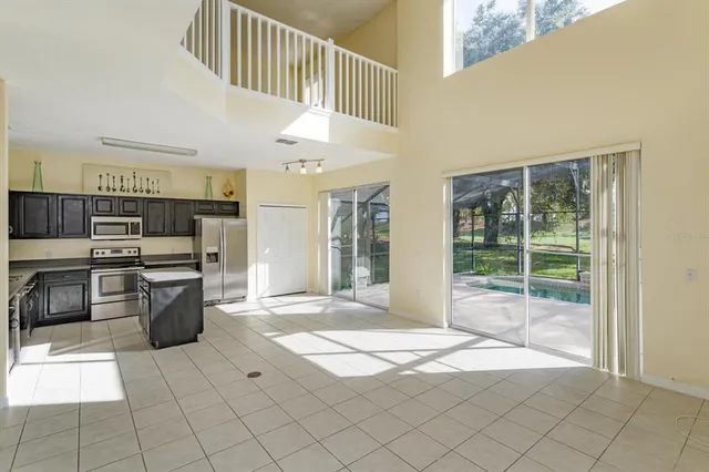 a open kitchen with stainless steel appliances granite countertop a stove a sink and a refrigerator
