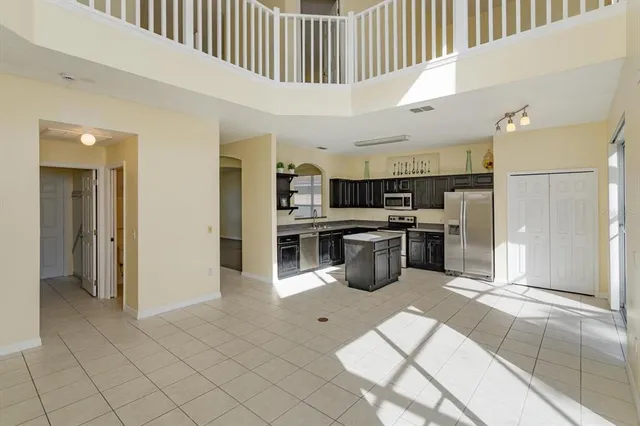 a open kitchen with cabinets and stainless steel appliances