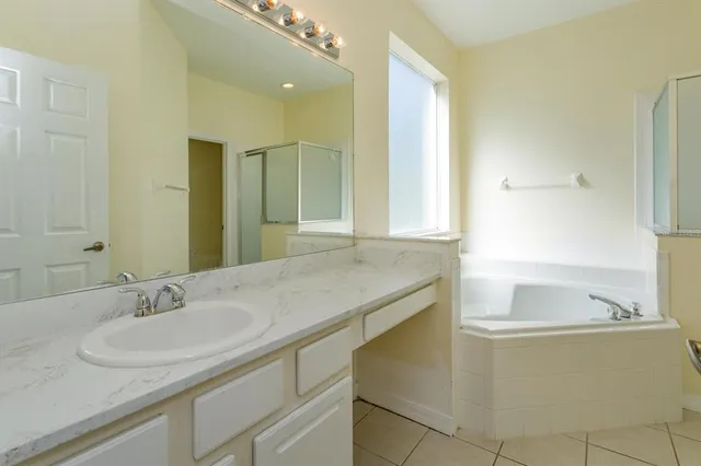 a bathroom with a granite countertop sink and a large mirror