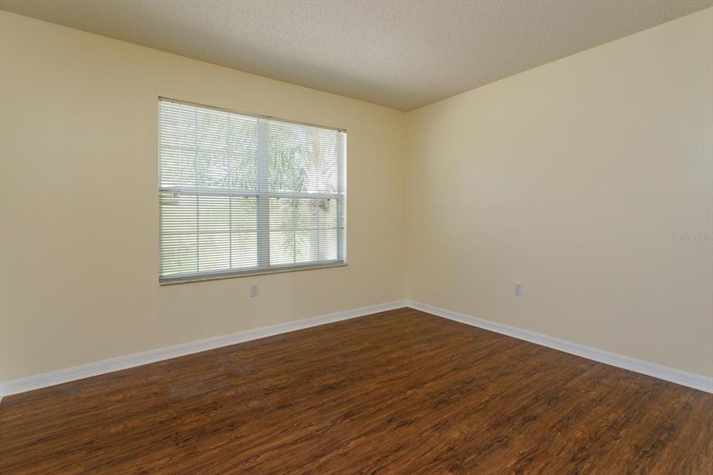 2833 Kokomo Loop Haines City, FL 33844 - Photo 18 of 30 wooden floor in an empty room with a window