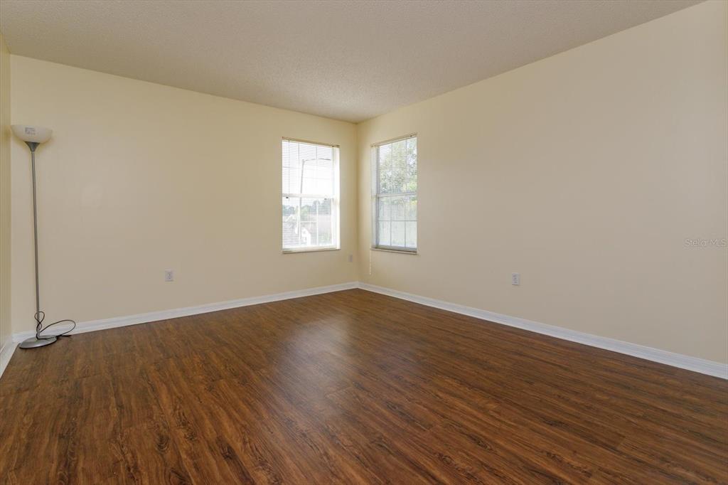 2833 Kokomo Loop Haines City, FL 33844 - Photo 20 of 30 an empty room with wooden floor and windows