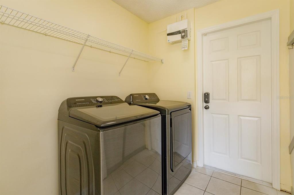 2833 Kokomo Loop Haines City, FL 33844 - Photo 25 of 30 a utility room with dryer and washer