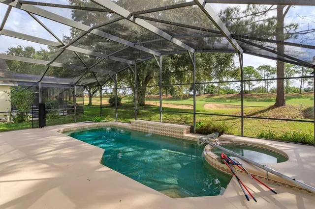 a view of a backyard with swimming pool