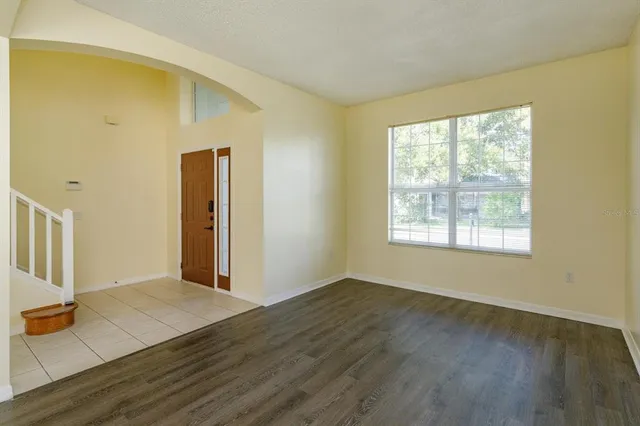 a view of a livingroom with wooden floor and a window