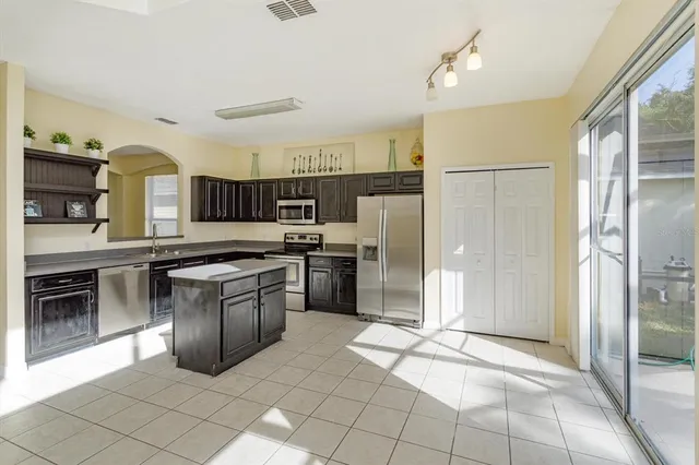 a kitchen with stainless steel appliances granite countertop a refrigerator and a sink