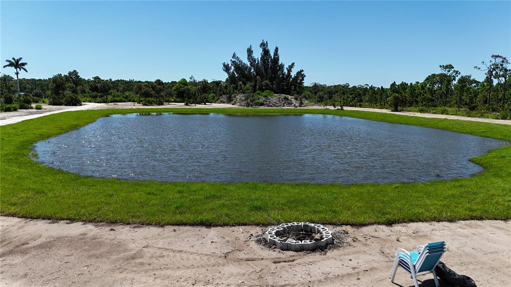 6455 Stringfellow Road St. James City, FL 33956 - Photo 12 of 33 a view of a lake with a yard and potted plants