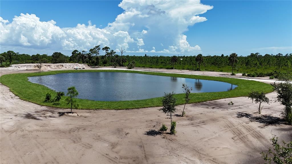 6455 Stringfellow Road St. James City, FL 33956 - Photo 18 of 33 an aerial view of a house with a garden and lake view