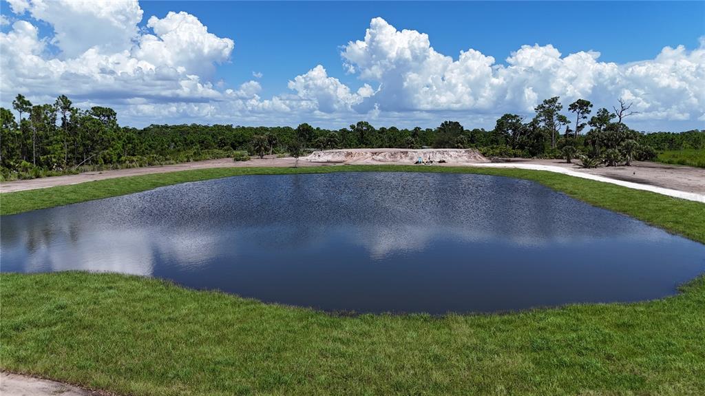6455 Stringfellow Road St. James City, FL 33956 - Photo 19 of 33 a view of a lake with a big yard