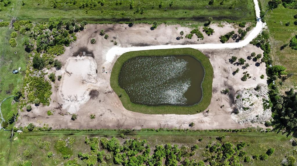 6455 Stringfellow Road St. James City, FL 33956 - Photo 20 of 33 an aerial view of a house with a yard and large trees