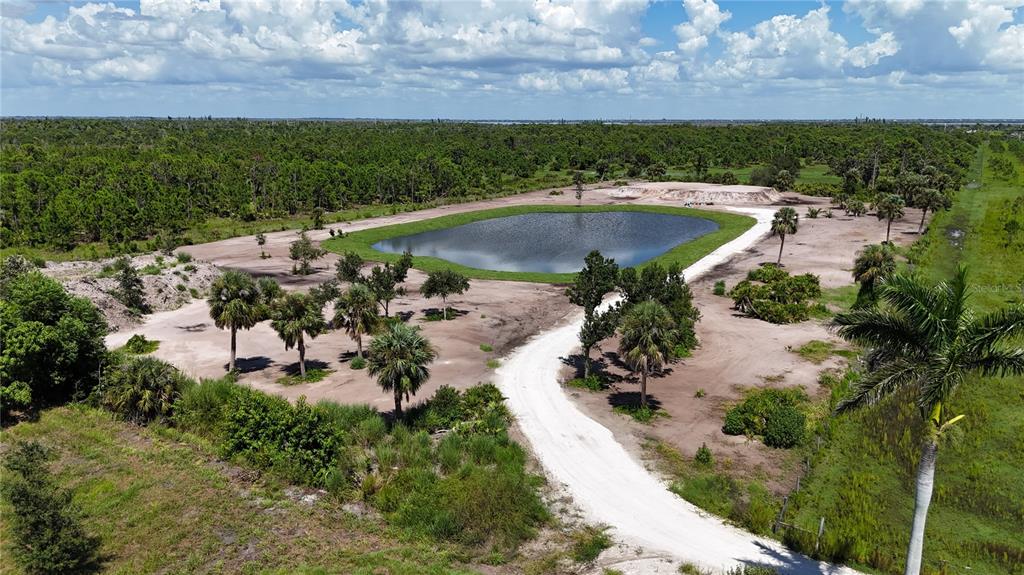 6455 Stringfellow Road St. James City, FL 33956 - Photo 2 of 33 a view of a lake with a yard