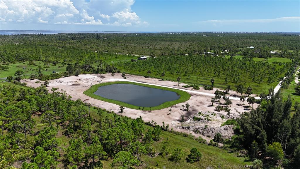 6455 Stringfellow Road St. James City, FL 33956 - Photo 6 of 33 a view of a lake with a yard