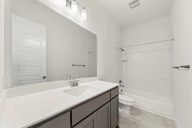 a kitchen with stainless steel appliances a sink a stove and cabinets