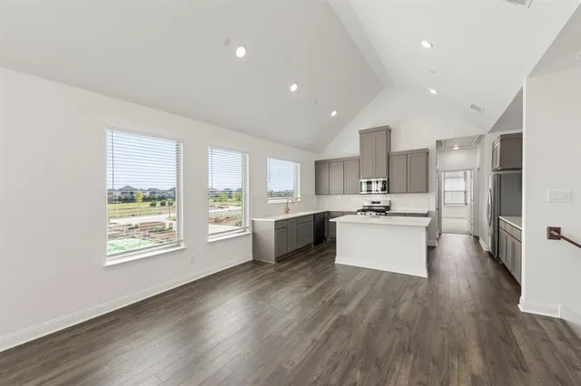 a kitchen with stainless steel appliances a sink stove and refrigerator