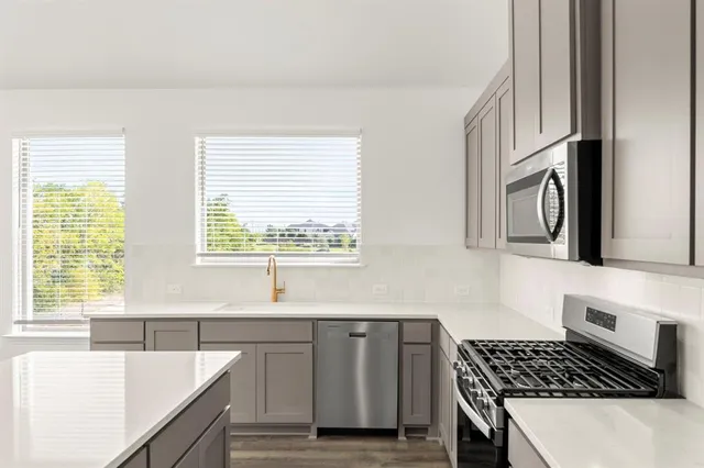 a bathroom with a double vanity sink mirror and shower