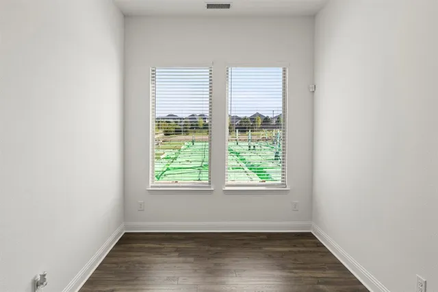 a view of room with wooden floor