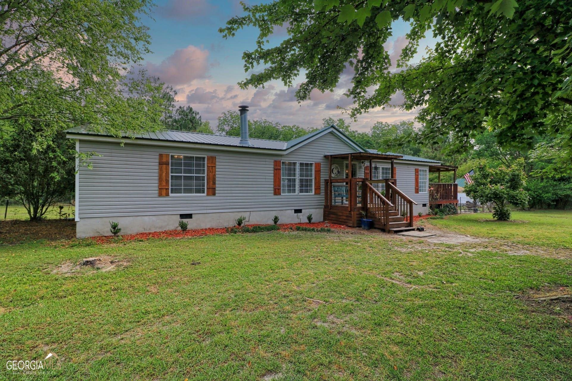 a front view of house with yard and green space