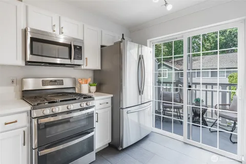 a kitchen with wooden cabinets and stainless steel appliances