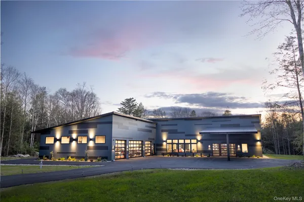 a front view of building with yard and green space