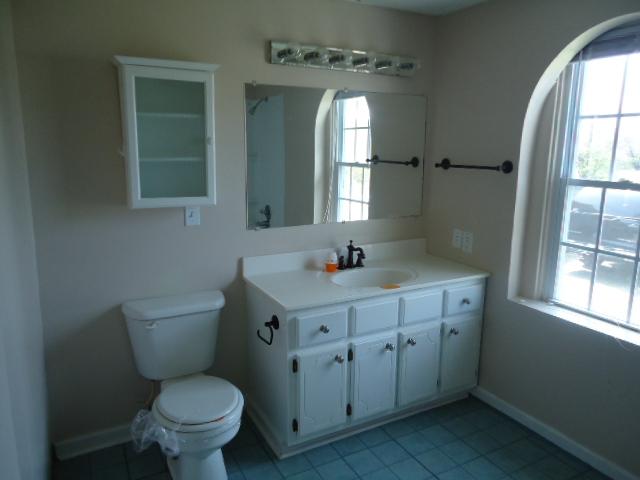 513 Forest Park Road Madison, TN 37115 - Photo 8 of 9 a bathroom with a toilet sink and mirror