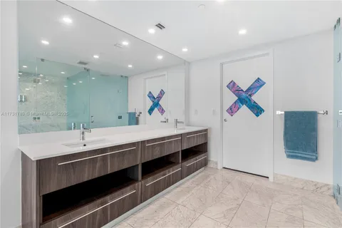 a spacious bedroom with a bed a table and chairs