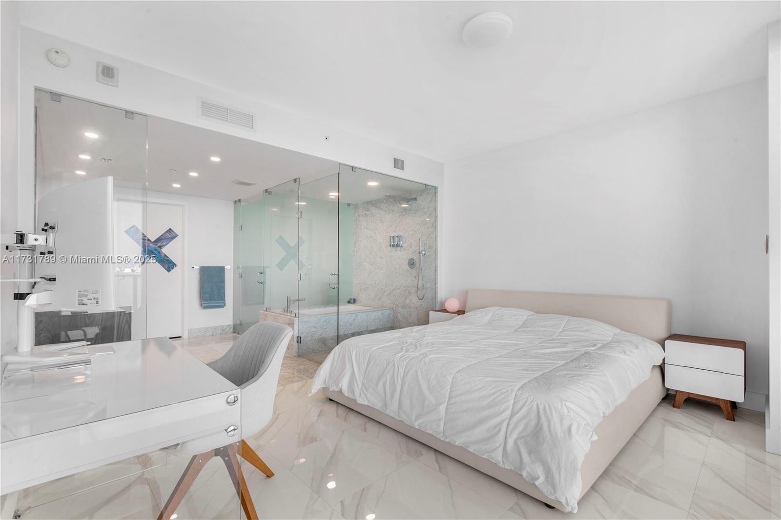 3131 Northeast 7th Avenue, Unit 1902 Miami, FL 33137 - Photo 14 of 20 a spacious bedroom with a bed a table and chairs