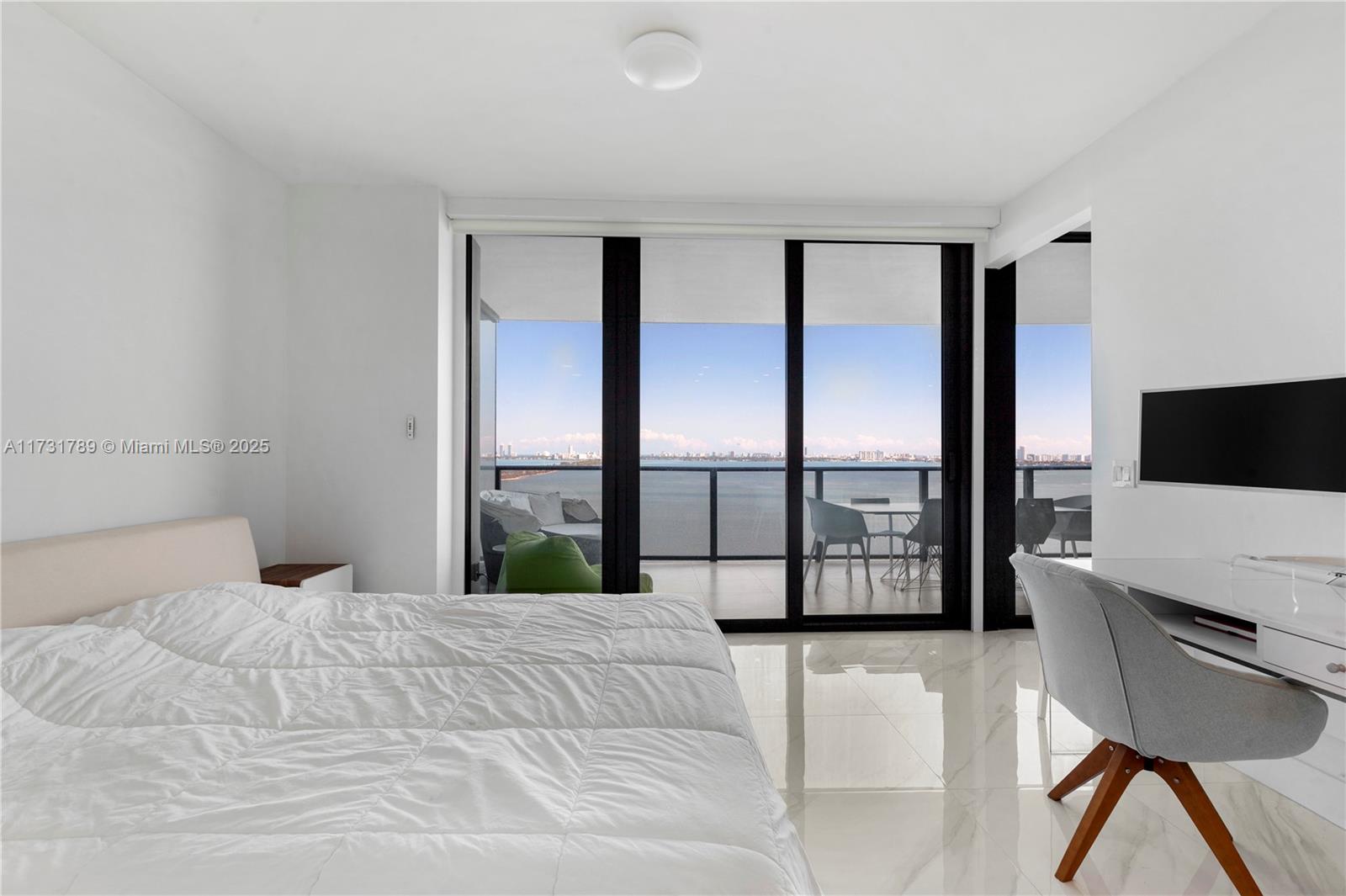 3131 Northeast 7th Avenue, Unit 1902 Miami, FL 33137 - Photo 15 of 20 a bedroom with a large bed and a large window