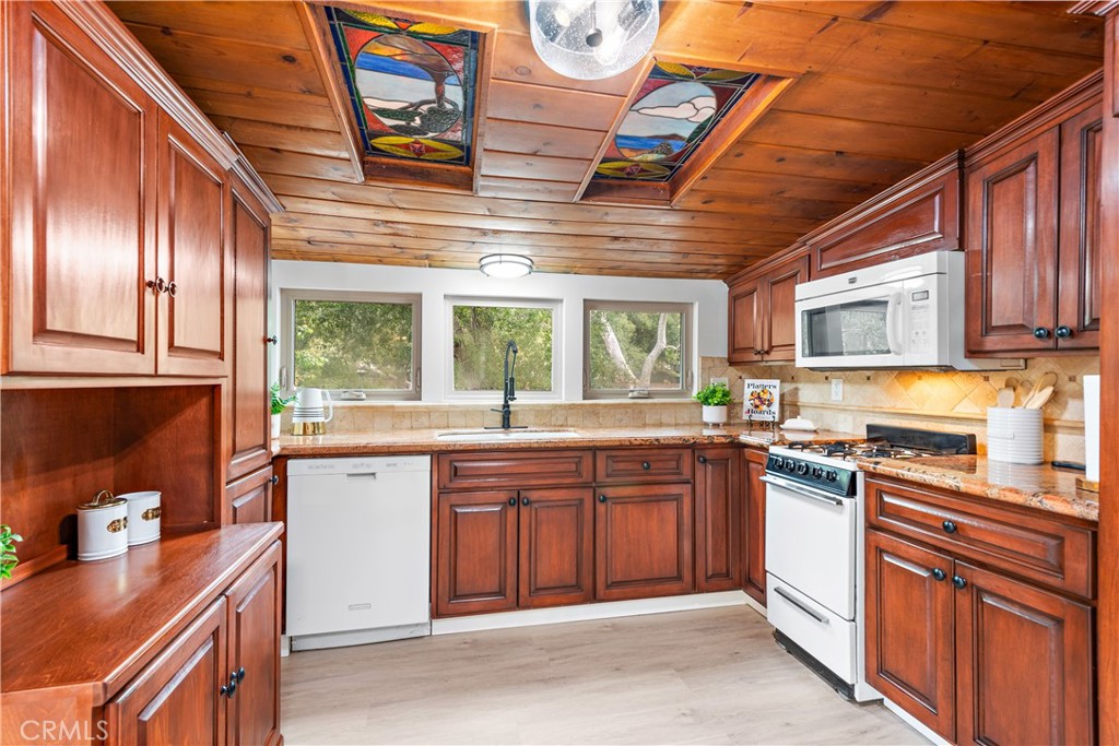 29229 Hazel Bell Drive Silverado, CA 92676 - Photo 10 of 39 a kitchen with stainless steel appliances granite countertop a stove sink and cabinets