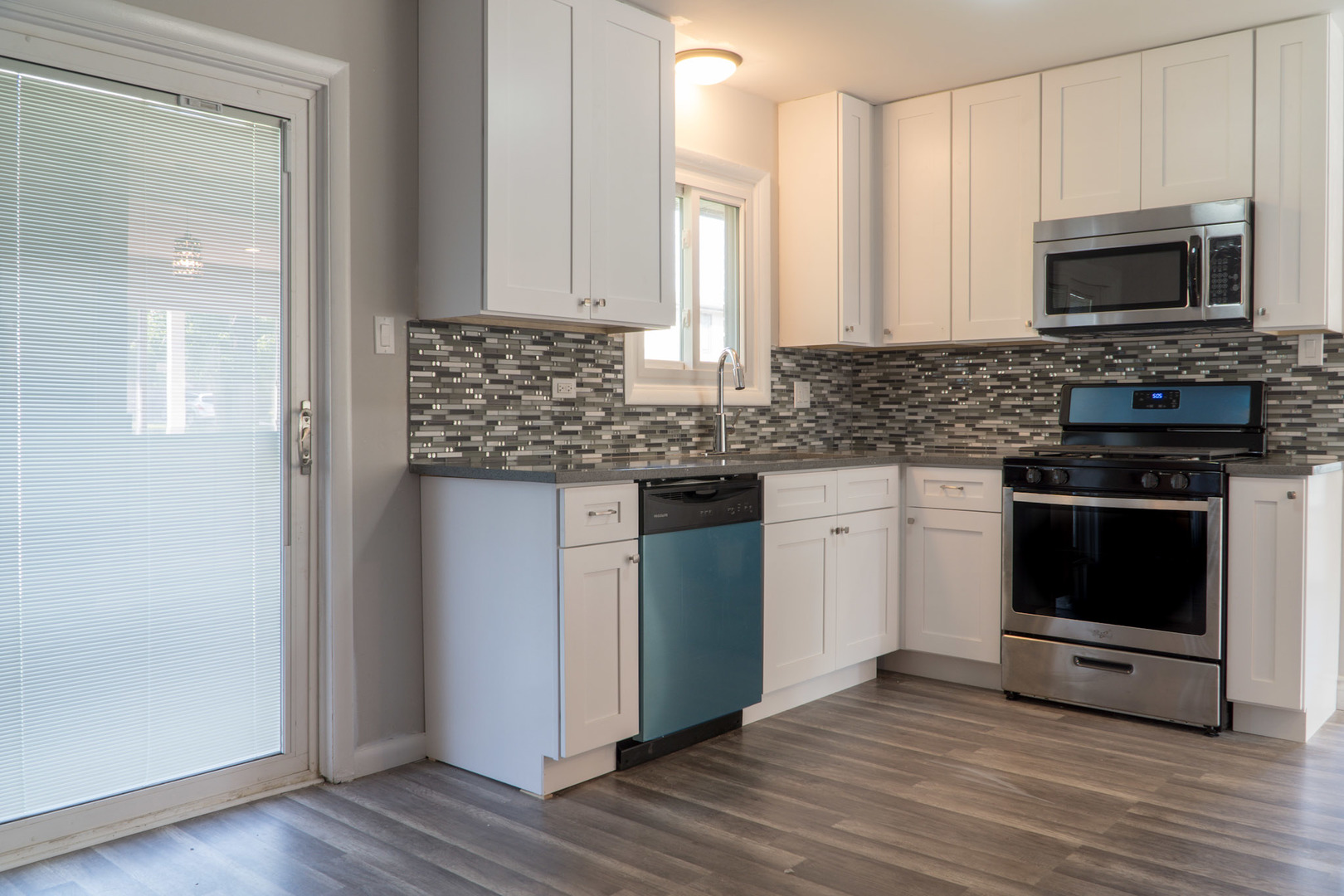 18406 Bock Road Lansing, IL 60438 - Photo 4 of 20 a kitchen with granite countertop a stove and a microwave