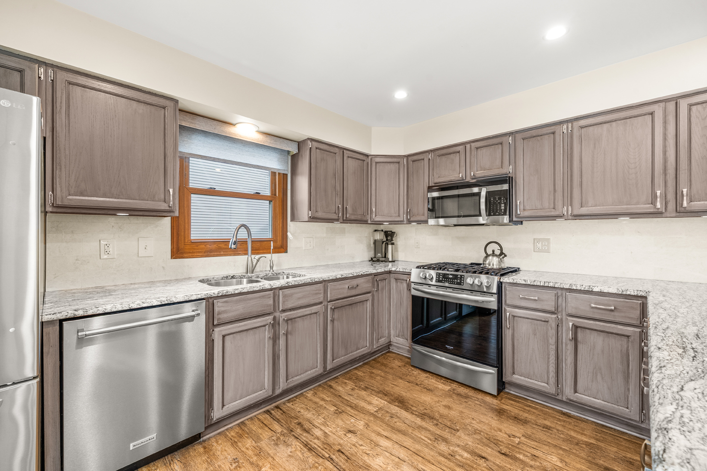 540 Parkside Drive Elburn, IL 60119 - Photo 13 of 38 a kitchen with stainless steel appliances granite countertop a sink and stove top oven