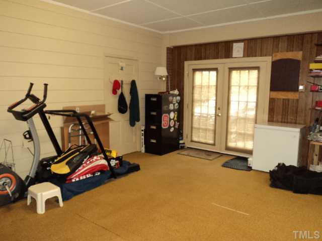 907 Pebblebrook Drive Raleigh, NC 27609 - Photo 13 of 25 Bonus room has lots of options. Door to workshop is on the left wall. Workshop has storage and access to attic space (pull down stairs on 2nd floor also goes to an attic). Bonus Room
