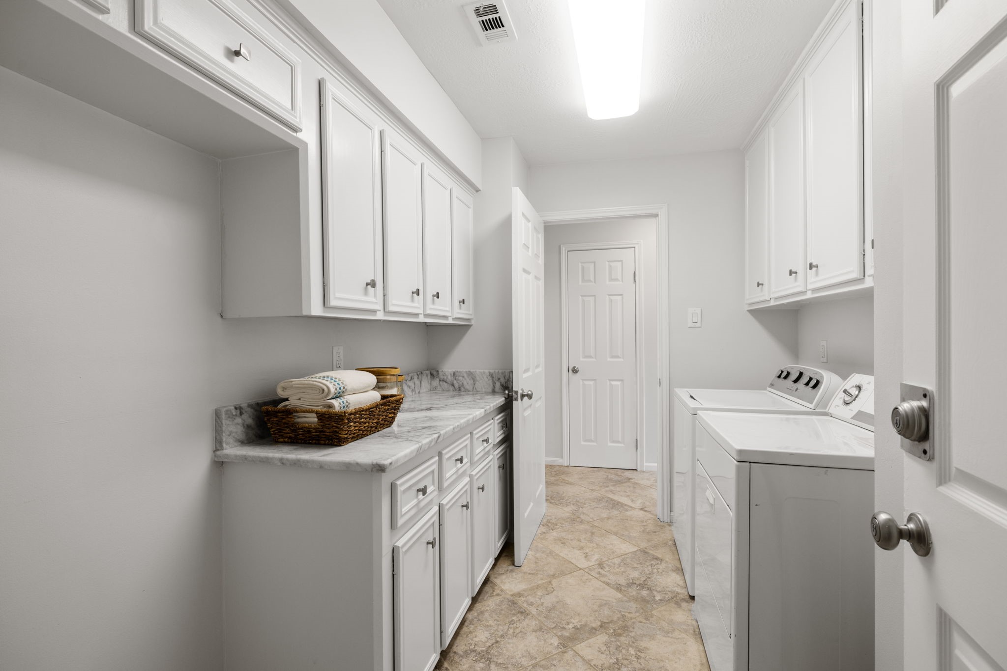 9203 Godstone Lane Spring, TX 77379 - Photo 19 of 49 The first-floor Utility Room serves as your laundry and mud room. You’ll love the overflow storage including upper and lower cabinets, marble countertop and storage closet.
