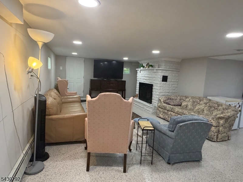 775 Tabor Road Morris Plains, NJ 07950 - Photo 3 of 21 a living room with furniture a fireplace and a chandelier
