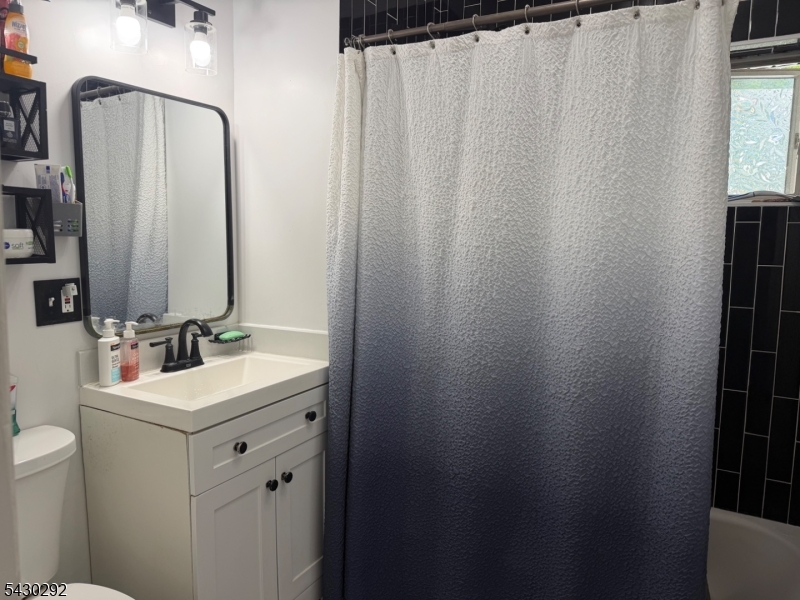 775 Tabor Road Morris Plains, NJ 07950 - Photo 9 of 21 a bathroom with a sink a toilet and mirror