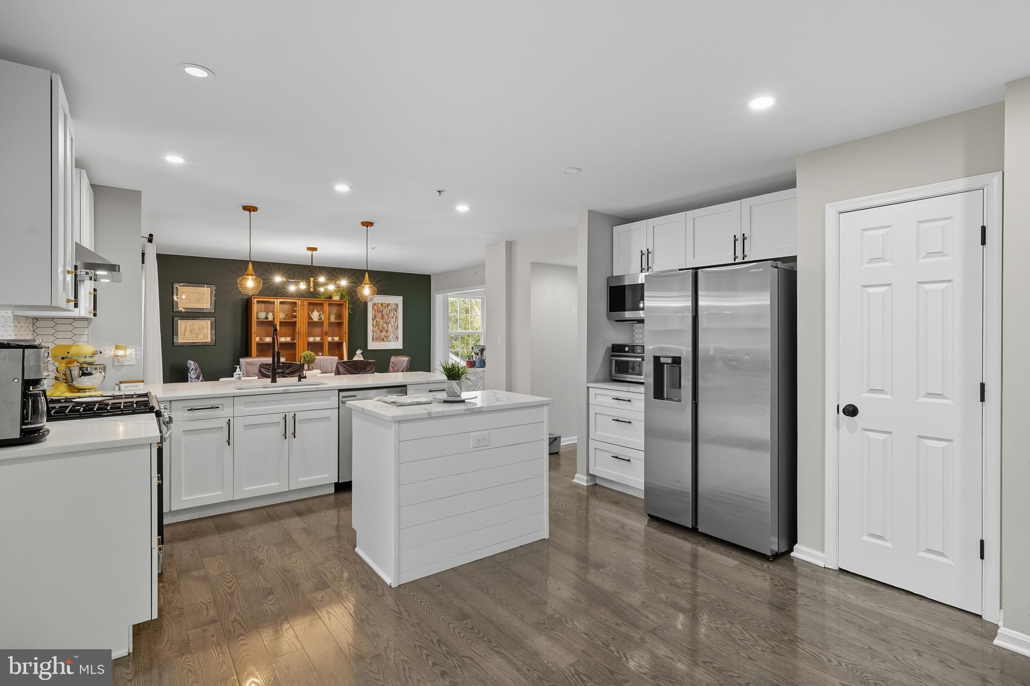 3100 Hillside Avenue Cheverly, MD 20785 - Photo 13 of 58 a kitchen with white cabinets and stainless steel appliances